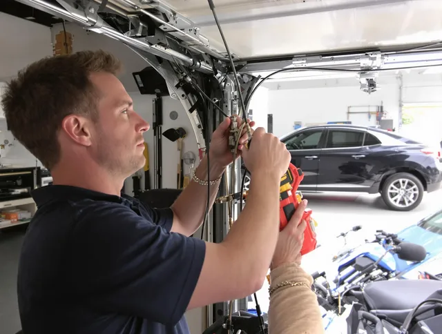 Strongsville Garage Door Repair safety certified technician performing cable replacement in Strongsville